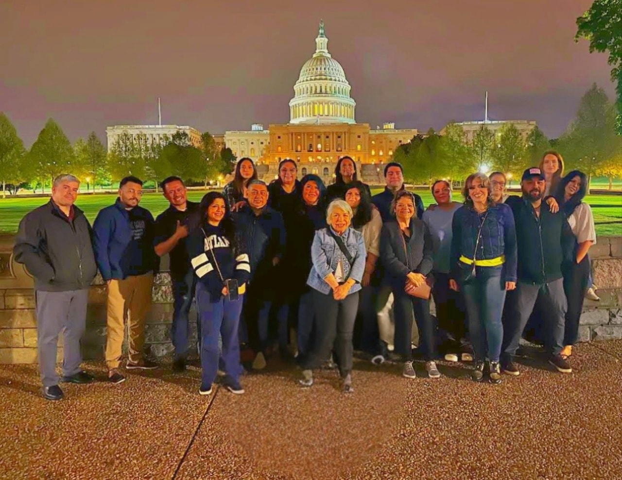 Barbara Casanova with a group at the U.S. Capitol at night